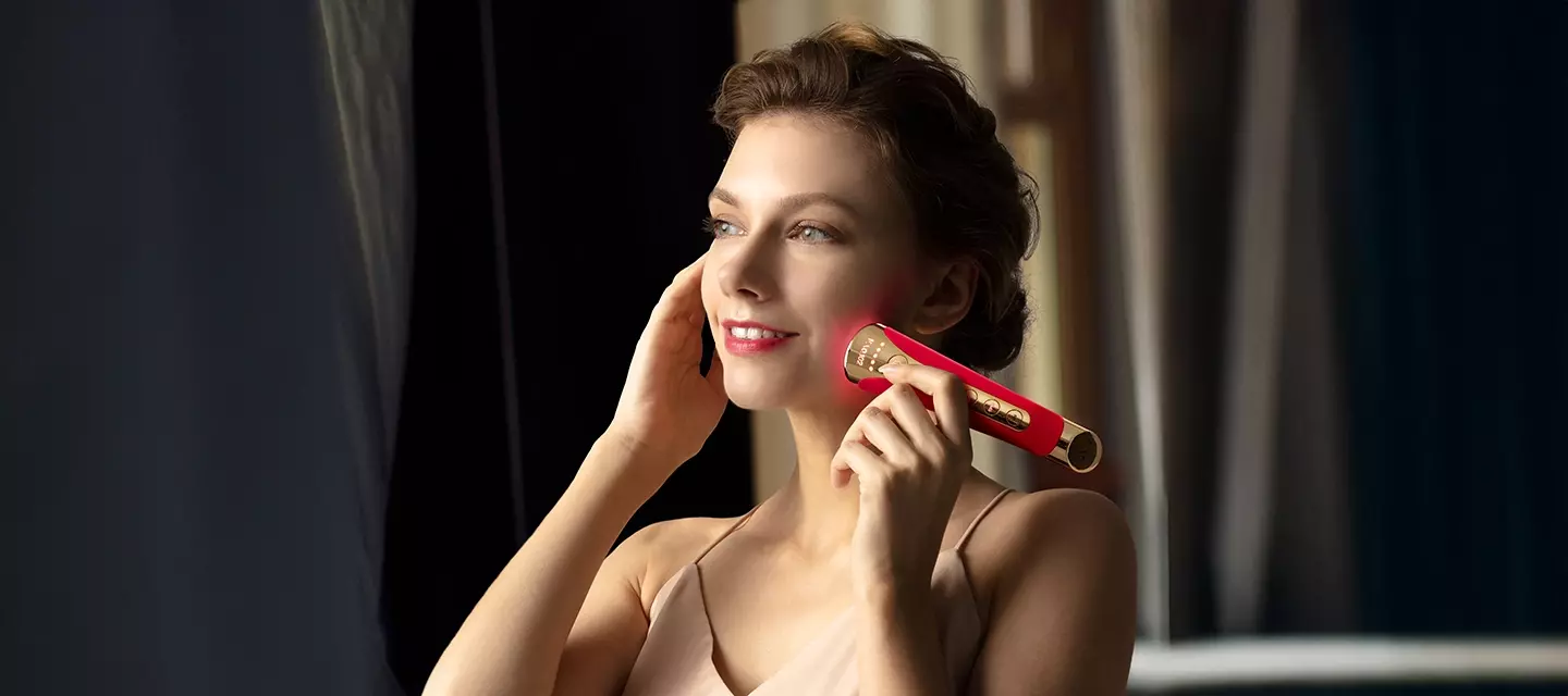 A beautiful woman using FAQ™ 102 device in an elegant, dark ambiance